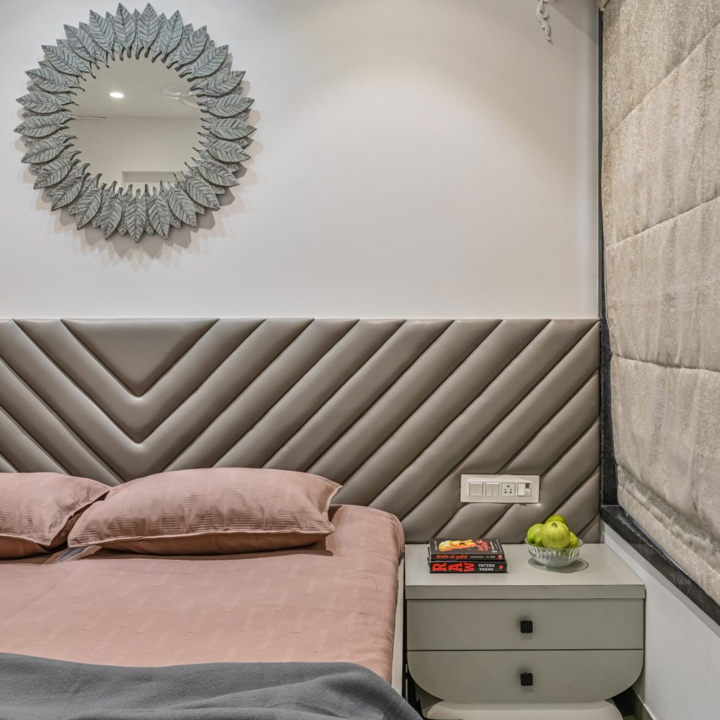 Elegant and spacious bedroom featuring a king-sized bed,neutral kota tones and decorative mirrors on the wall with subtle mouldings