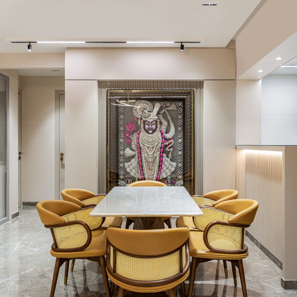 L"Art-filled living room with a diamond cladded shrinathji frame wall and open kitchen feel