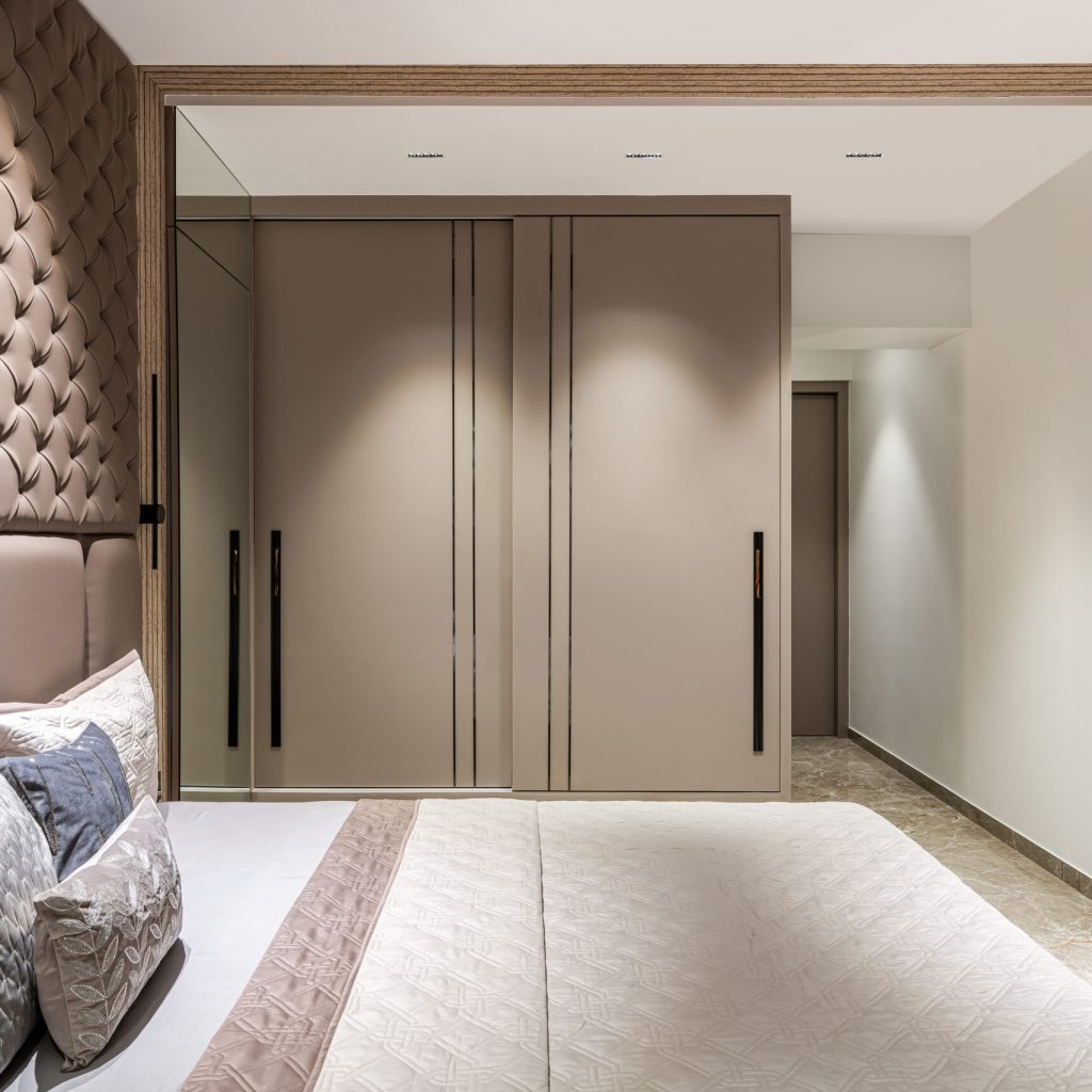 Luxurious neutral shade matt acrylic slding wardrobe with custom-made cabinetry and drawers.