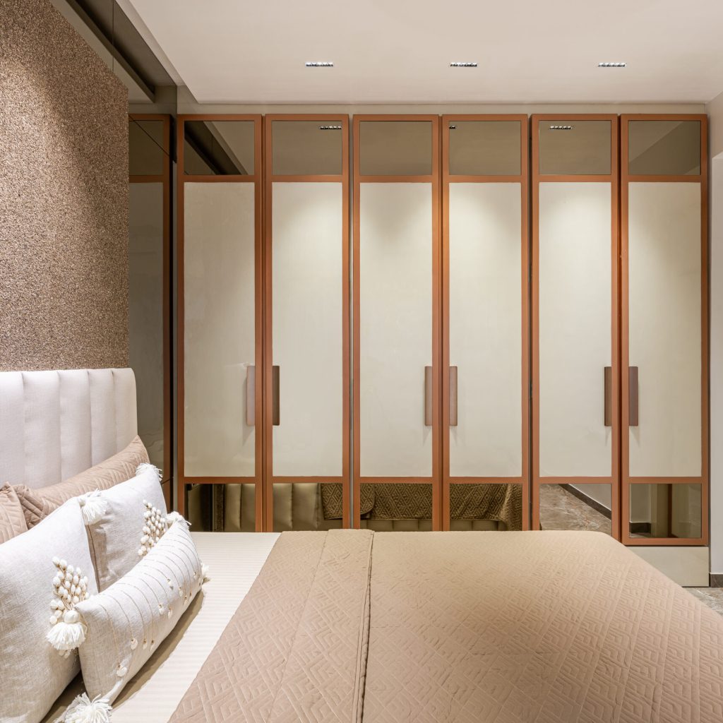 Luxurious wardrobe made with brown mirror and pearl while acrylic sheet with custom-made cabinetry and drawers.